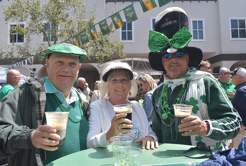 Herm Hipson, Denise Hodge and Bill Nicholson enjoy Irish-themed beer at the St. Patrick's Day celebration on Lakewood Main Street.