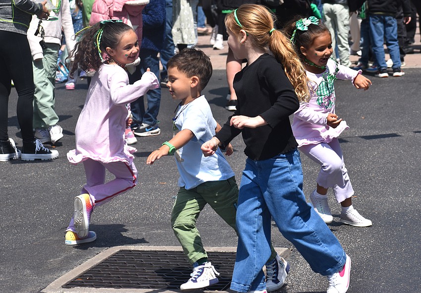 Lakewood Ranch's Rhiannon O’Malley, Charlie O’Malley, Quinn Cannon 
and Annabelle O’Malley let their energy out at the St. Patrick's Day celebration by running in circles.