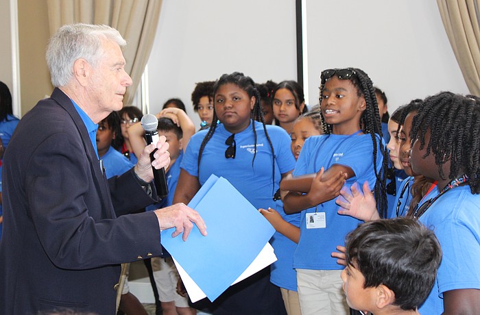 Ted Lindenberg thanks students from Rogers Garden Elementary for singing a couple songs during the Books for Kids annual luncheon at Lakewood Ranch Country Club March 12.