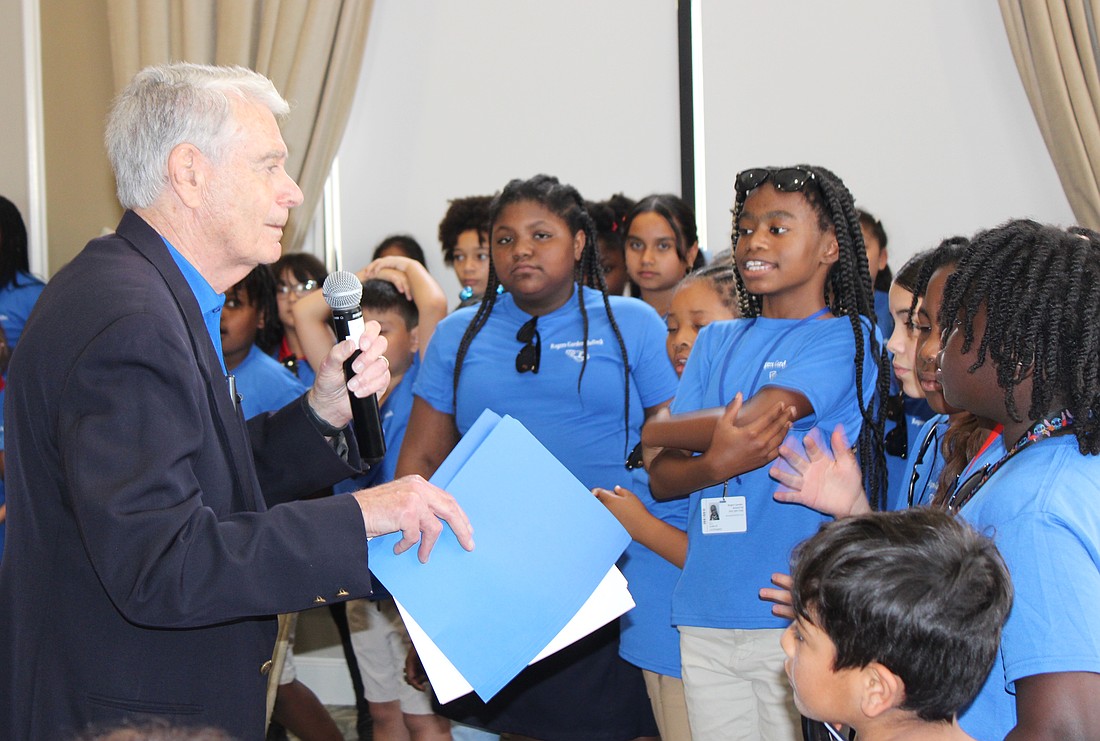 Ted Lindenberg thanks students from Rogers Garden Elementary for singing a couple songs during the Books for Kids annual luncheon at Lakewood Ranch Country Club March 12.