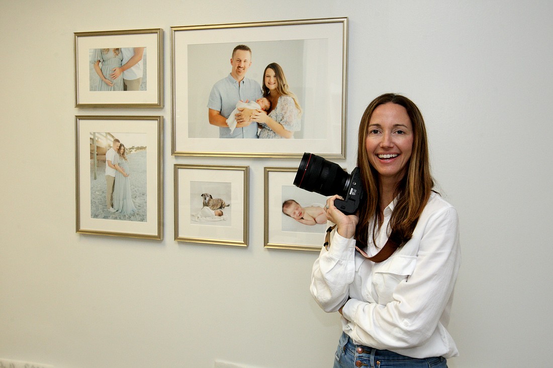 Laura Davis with a small gallery of maternity and newborn photos she took for a client’s family.