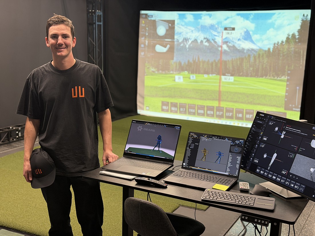 Kevin Bane, athlete services manager for Audens Golf Performance, stands in front of the Gears 3D Motion Capture hitting bay that uses cameras to track a golfer’s swing.