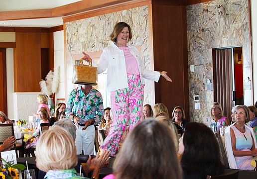 Mary Schultz shows off the latest Lilly Pulitzer style on the St. Mary, Star of the Sea, Women's Guild spring fashion show March 16 at the Sarasota Yacht Club.