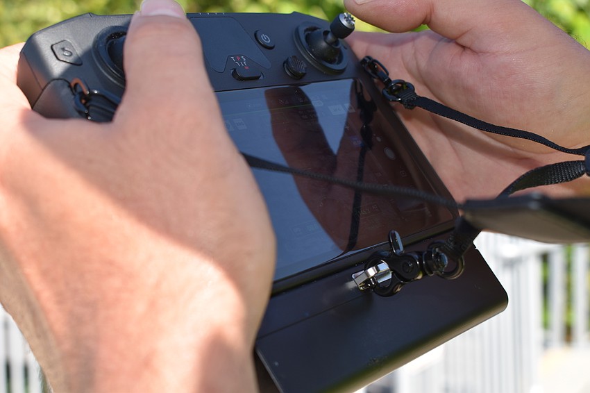 An operator flies a DJI drone in 2021 during a monitoring flight for red tide over the Longboat Key beach.