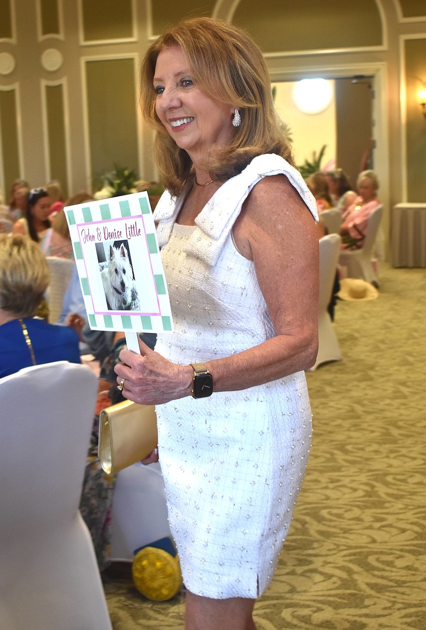 Model Denise Little models a pearl dress from Lilly Pulitzer while walking the runway for Divas and Dogs on March 20.