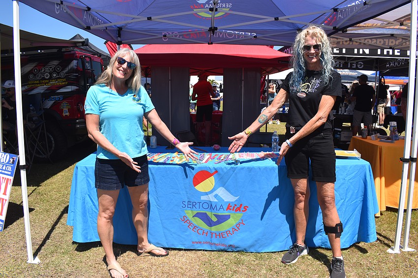 Pam Plank, the executive director of Sertoma Kids, and volunteer Debby Greer run the booth to let festival goers learn how the money raised will help children with speech and language needs.