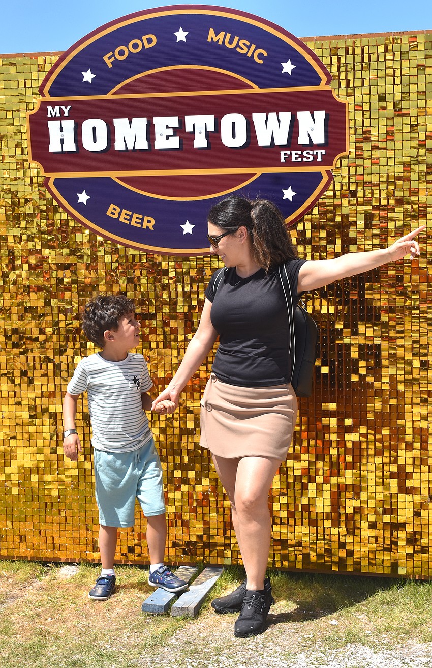 Bradenton's Nico Ramon, 6, and Lis Arias pose for a photo in front of the My Hometown Fest sign.