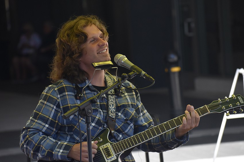 Zack Pomerleau performs at the market.
