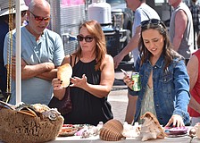 Glenn and Linda Courtney and their daughter Chelsea Courtney look at seashells.