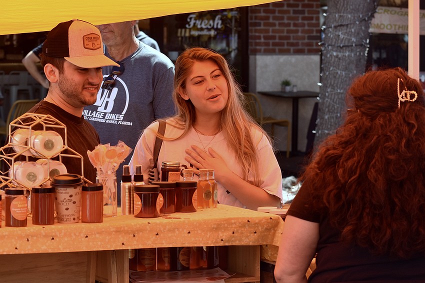 Jacob Alalof and Jordyn Cheesler talk with Alma Johnson of Sarasota Honey Company.