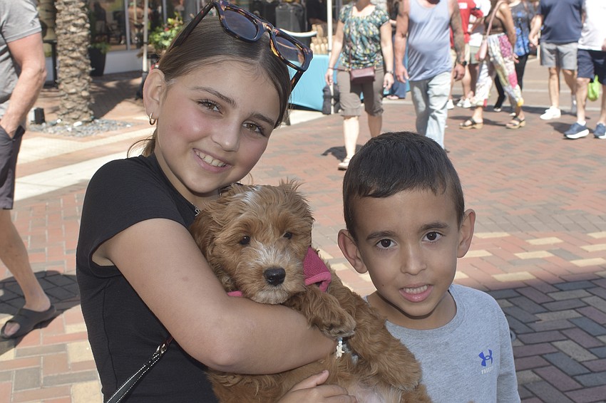 Alivia Redding, 10, her brother Hudson Redding, 6, and their dog Lulu enjoy the market.