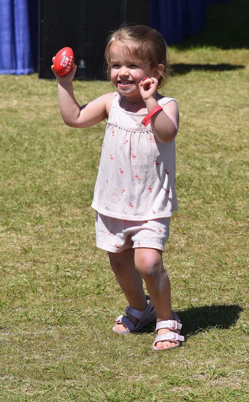 Sarasota's Scarlett Fricker, 3, runs around with a red ball to the tunes of Fleetwood Mac cover band Sweet Fleet.