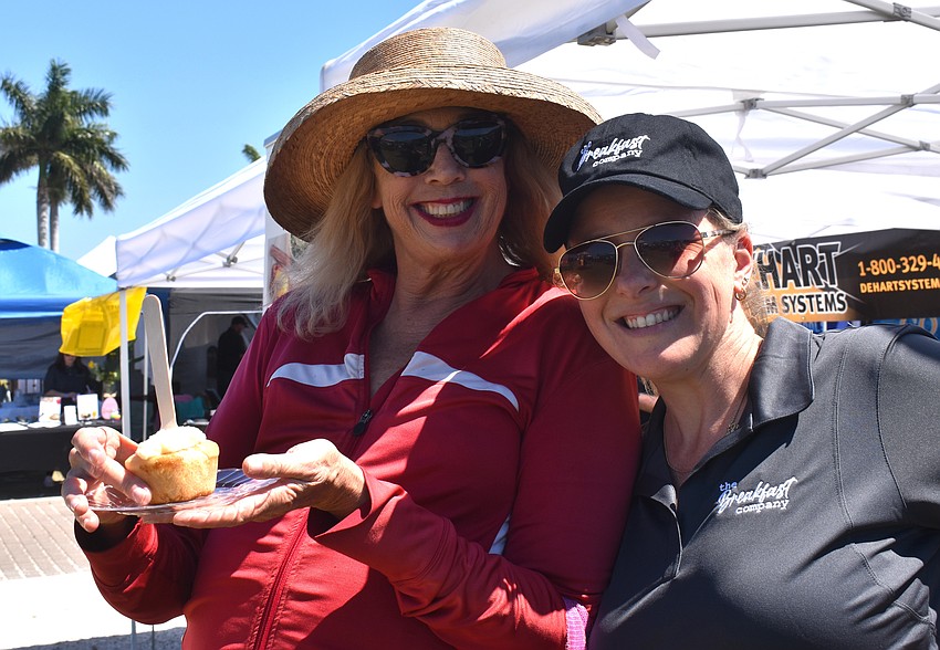 Denise Blondo gets a cinnamon roll from The Breakfast Company with the help of Maegan Angeles at My Hometown Fest.