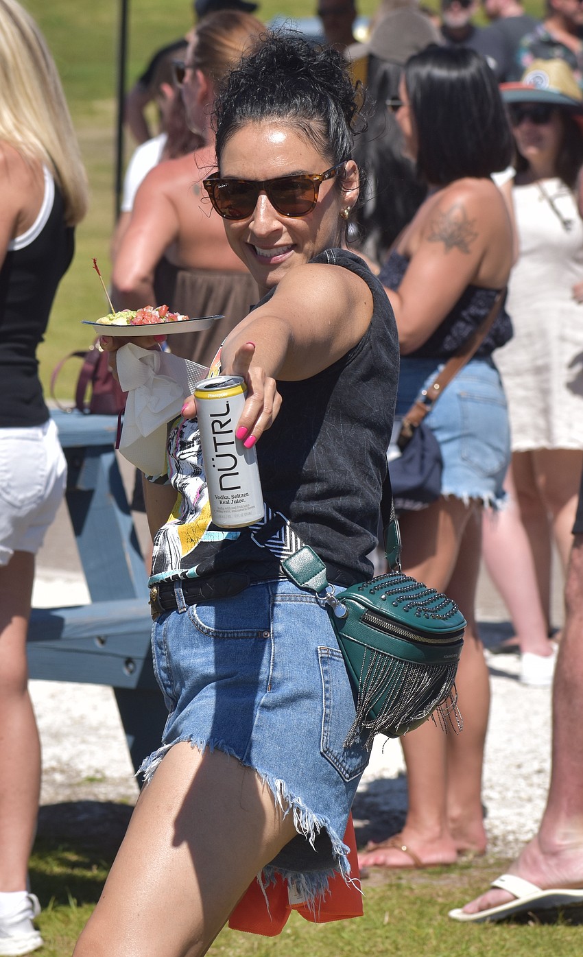 Sarasota's Brandy Aguirre doesn't let having food and a drink in her hand stop her from dancing at My Hometown Fest.