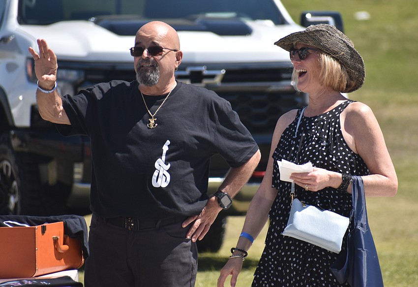 John Santiago and Linda Logan stand on the sidelines and listen to the tunes of J Santi & The Vital Groove at My Hometown Fest on March 21.