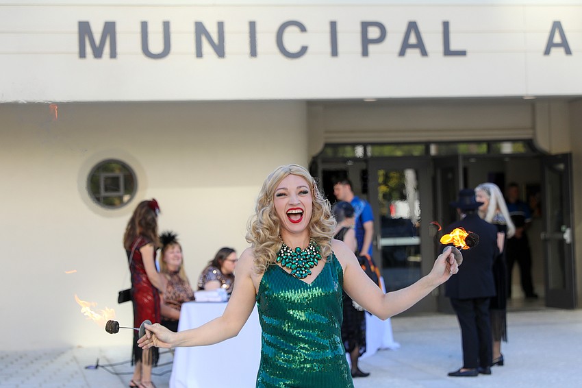 Heather Blount Elliot flames to please as guests register for the Beaux Arts Ball.