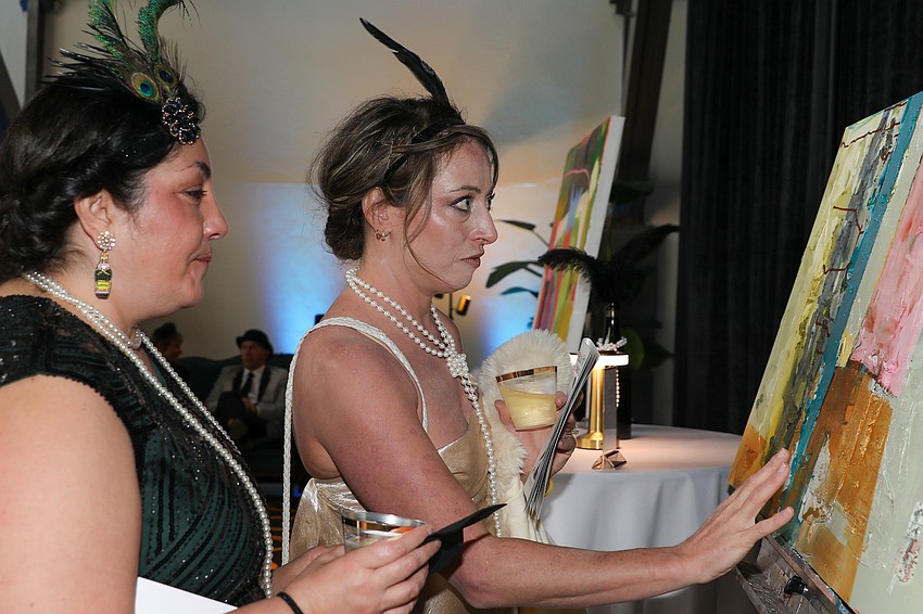 Laura Brown and Holly Malave explore a painting together.