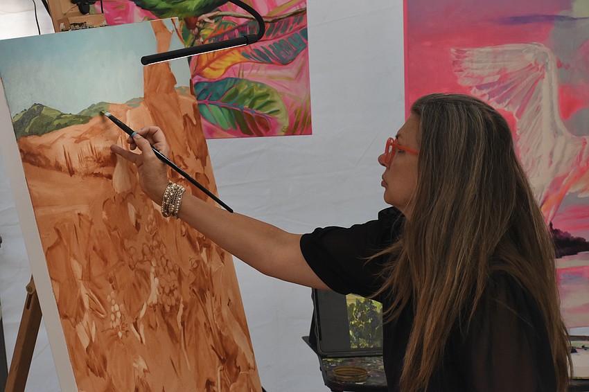 Artist Stephanie Linden works on a painting.