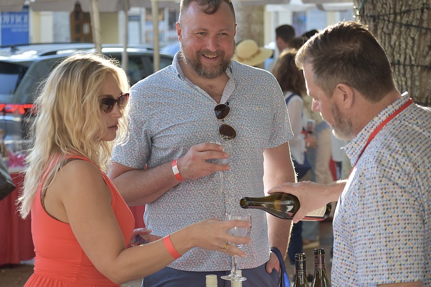 Jamie Turner and Matthew Etre of Connecticut receive wine from Rob Stegall of Marimar Estate Vineyards & Winery.