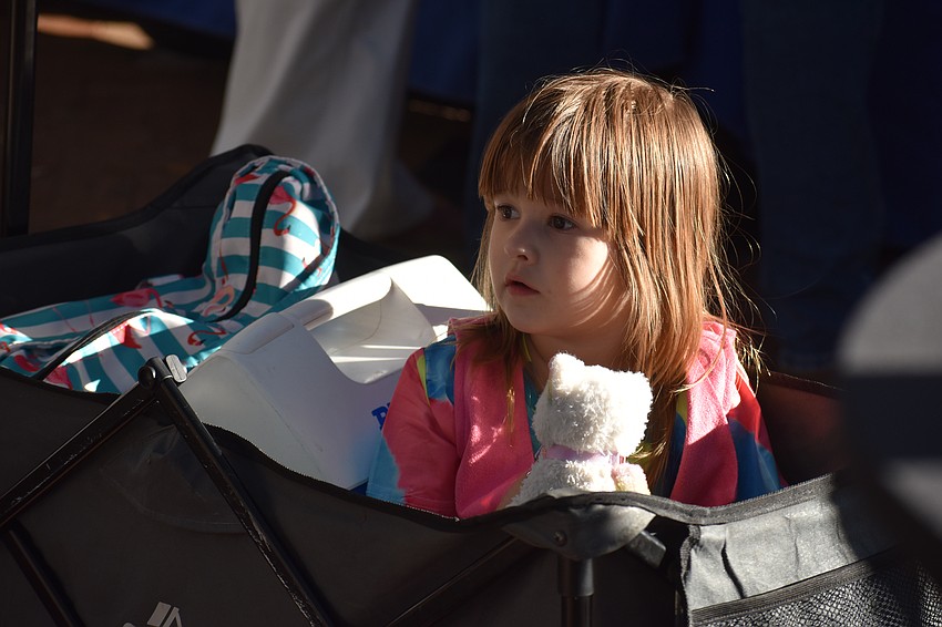 Olivia Joy Landrum, 3, looks out at the event from her wagon.
