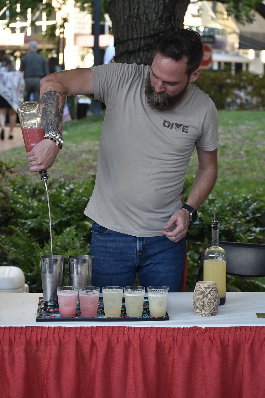 Michael McDaniel mixes some drinks.