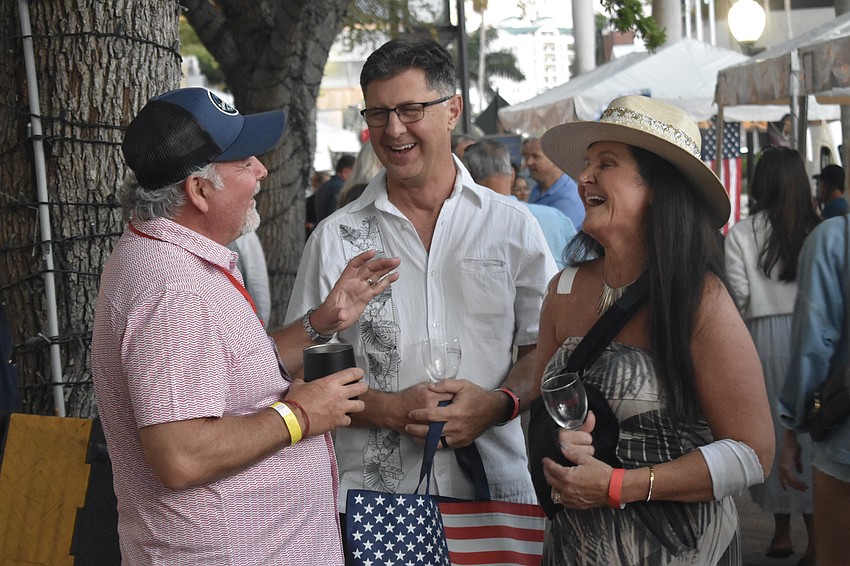 Tom Ilg talks with Chuck Pue and Kelley Hannan