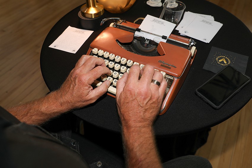 Steve McAllister types poems on demand during the Beaux Arts Ball reception.
