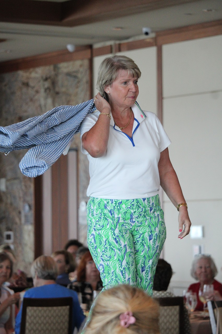 JoHanna Krempel gives an over-the-shoulder flick of her jacket during the fashion show.