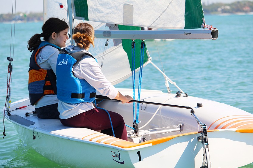 Youth sailors Madison Kueter and Rachel Ady work on reading the wind and waves to get ahead at the Next Tack regatta.