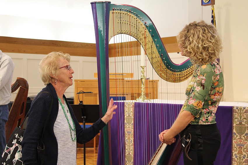 Fan Oleson chats with harp player Tasha Robinson after the show. She and Andrea Carver said they especially appreciated seeing the concert because Oleson's granddaughter plays the instrument.