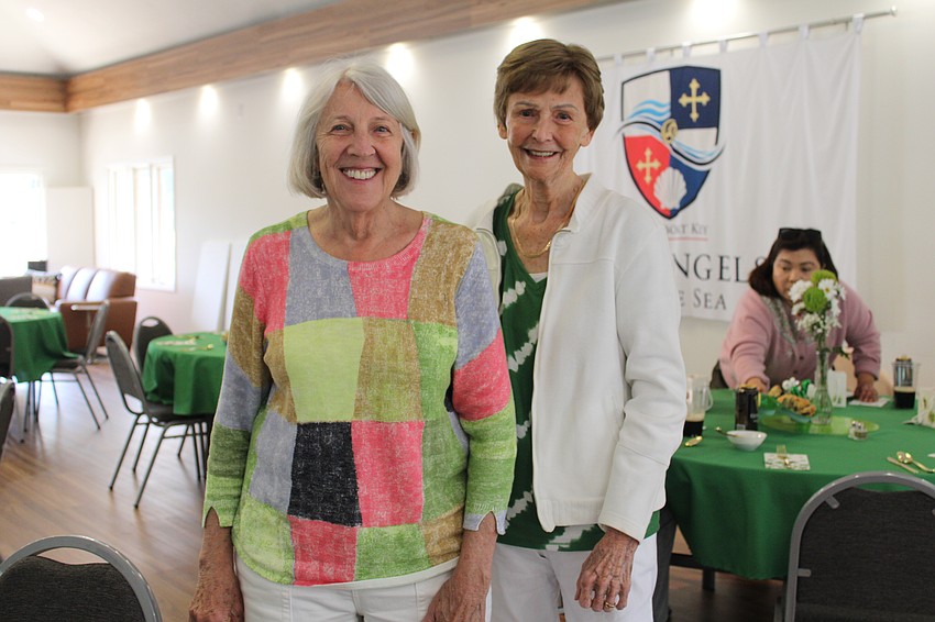 Paula Norwood and Beverly Henry get ready to sit down to the St. Patrick's Day dinner.