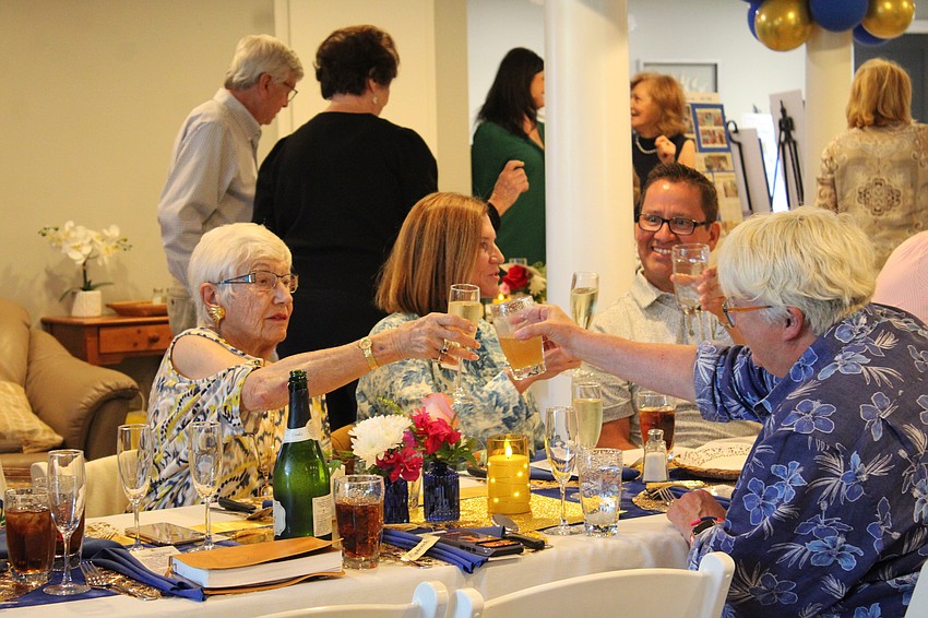 Trudy Katstra and friends cheers during the toast celebrating 70 years for Longboat Island Chapel.