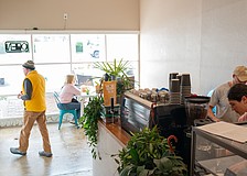 Co-owner Chris Carter works with a barista behind the counter of the second location of Sips, which opened at 3172 Gulf of Mexico Drive this month.