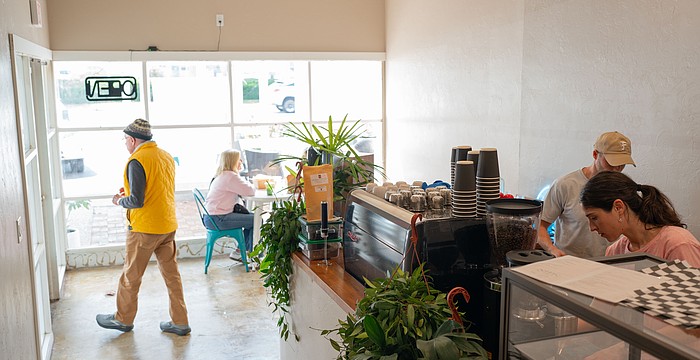 Co-owner Chris Carter works with a barista behind the counter of the second location of Sips, which opened at 3172 Gulf of Mexico Drive this month.