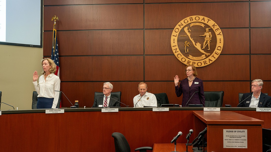 Debra Williams (standing left) and Penny Gold (standing right) were picked as mayor and vice mayor, respectively, at Longboat Key’s Town Commission meeting Monday, March 23.