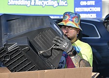 Nick Dazio disposes of a television.