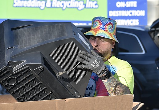 Nick Dazio disposes of a television.