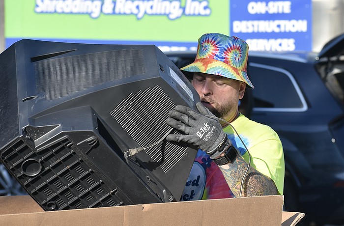 Nick Dazio disposes of a television.