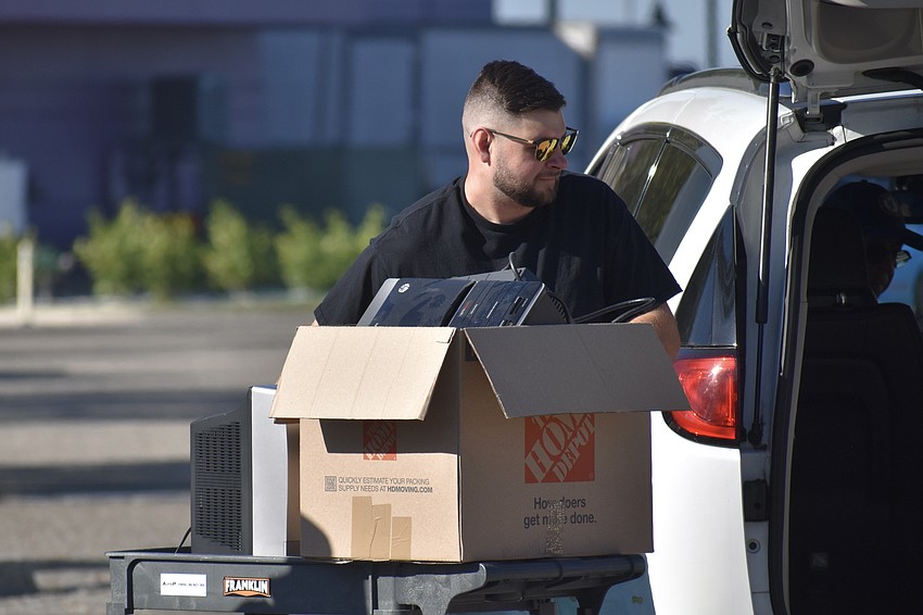 Brandon Crisp of Rocycle transports a box of electronics.
