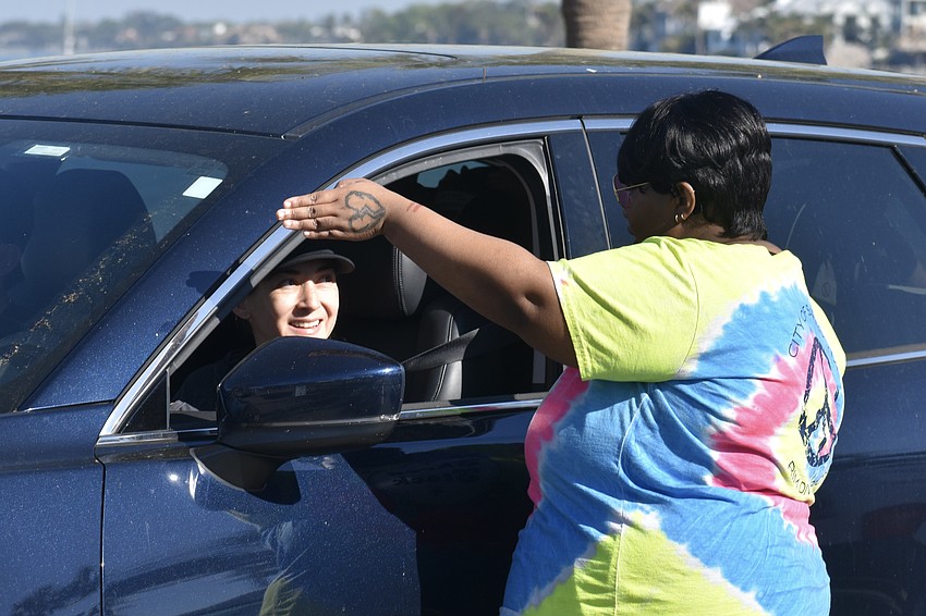 Natalia Gomez heads towards the recycling area as she talks with Sherrelle Gilliam.