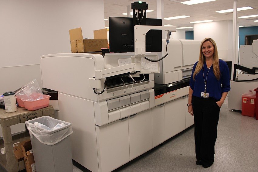 Megan Batty, the director of marketing at Lakewood Ranch Medical Center, stands next to one of the new analyzers that have been purchased for the hospital's tower expansion.