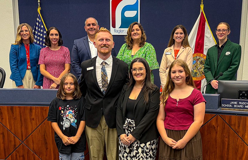 Joshua Walker, with his wife, Rebecca, and children Adeline (left) and Charlotte with Flagler County School Board. Courtesy Flagler Schools.