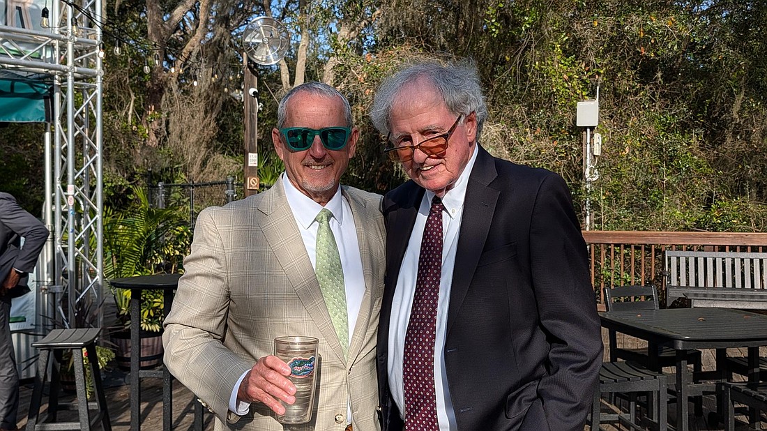 Patrick Canan, left, and Hank Coxe, presented this year’s tribute to the late 7th Circuit Judge Richard O. Watson at the annual Canan Law St. Patrick’s Day fundraiser for civil legal aid in St. Johns County.