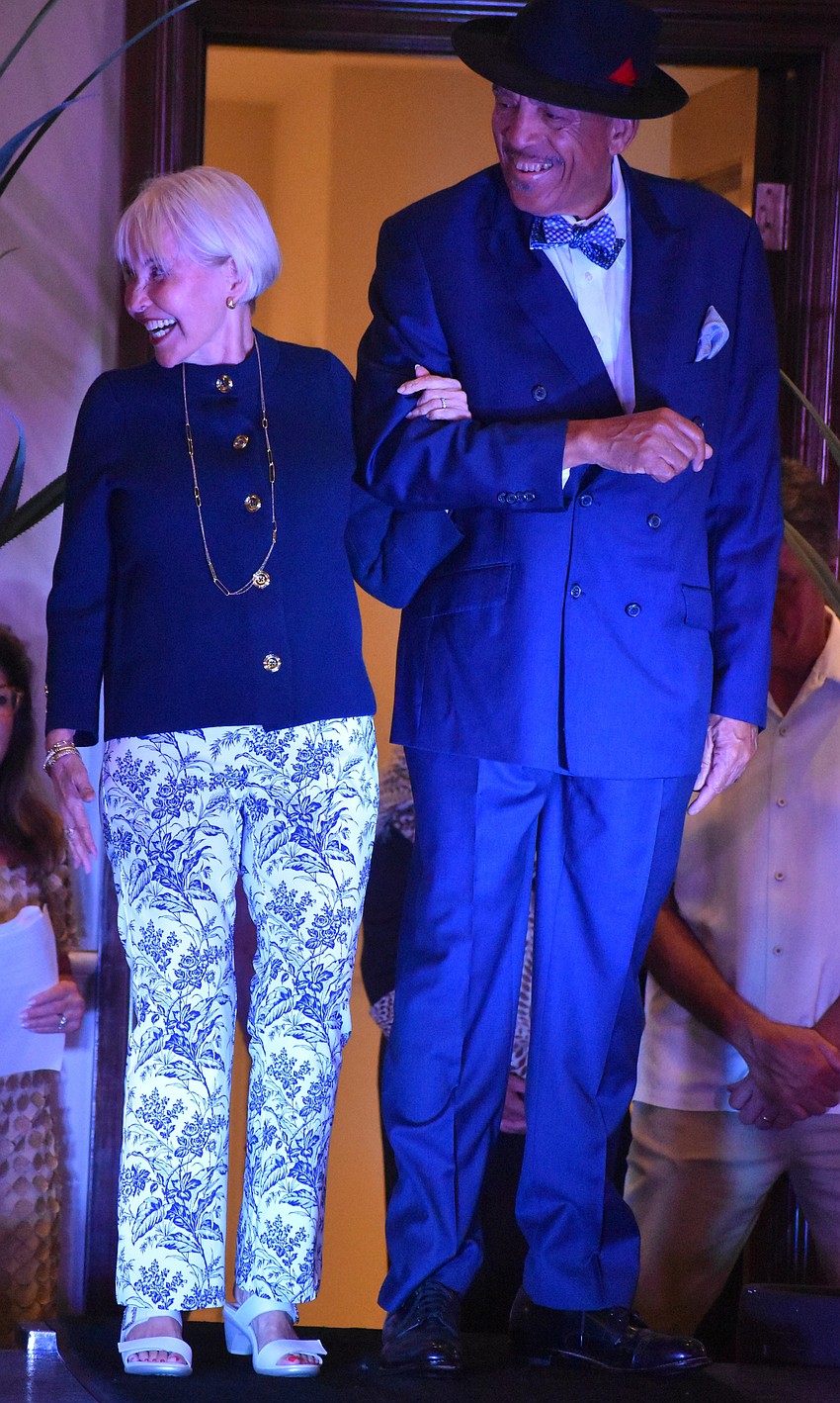 Andrea Mahan, wearing an outfit by J. McLaughlin and escorted by Wendell Lili, is a special interest group chair for the University Park Women's Club.