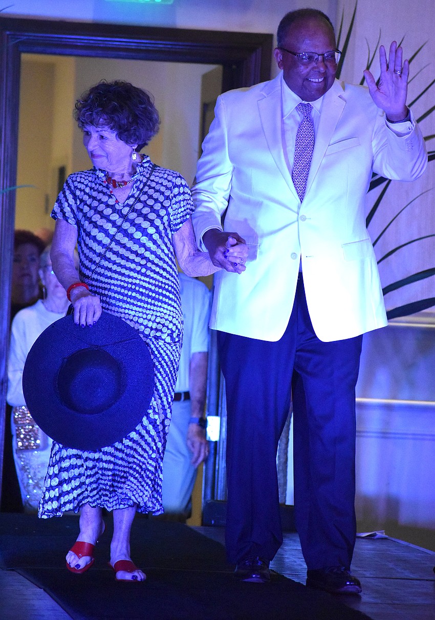 Pepi Levene, wearing an outfit by Darci's boutique and escorted by Ronald Mason, has been a member of the University Park Women's Club for 12 years and is the current chair of the book club.