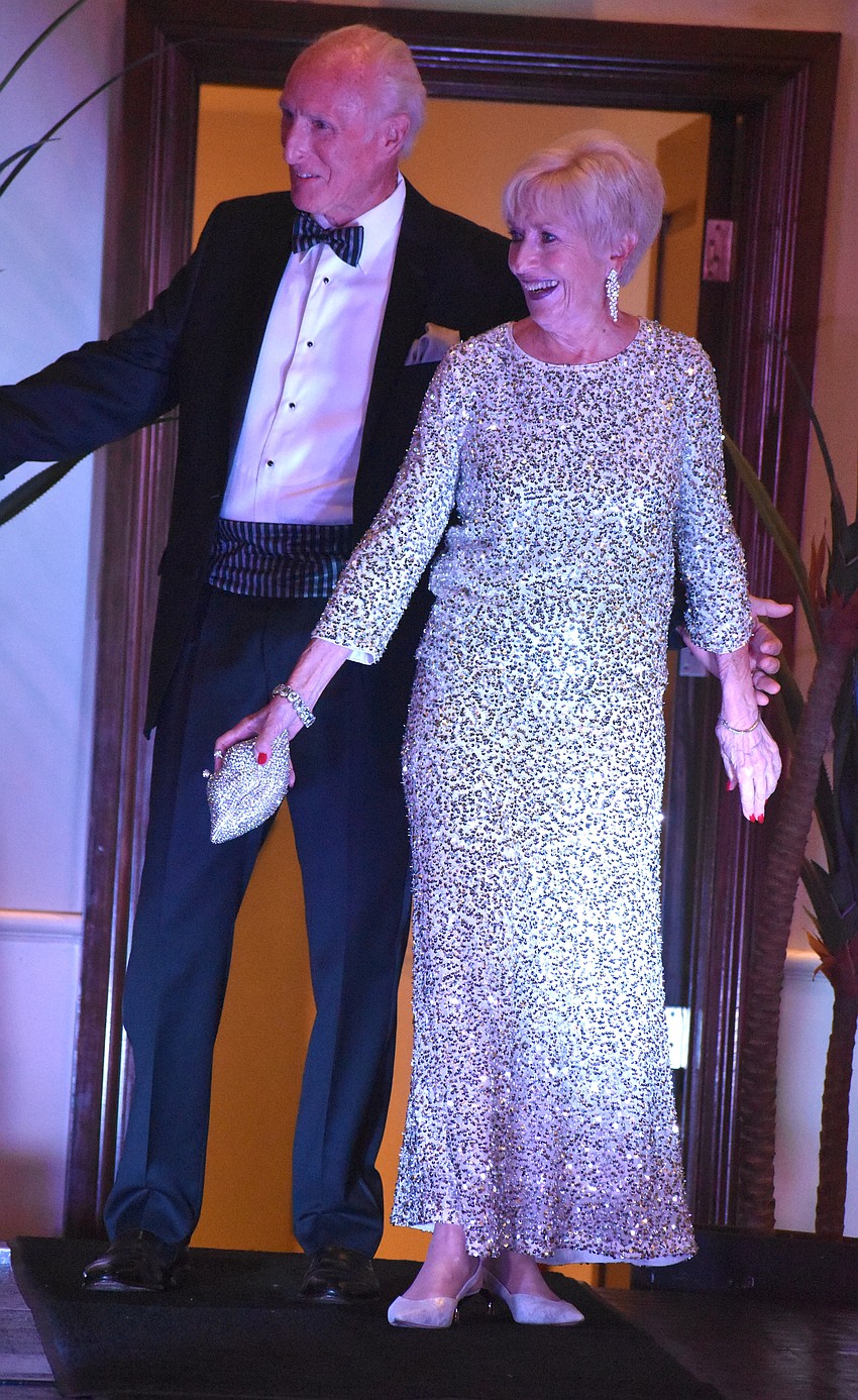 David Van Brundt escorts Terry Kees, a past president and a member of the University Park Women's Club for 14 years. Kees is wearing a gown from Darci's boutique.