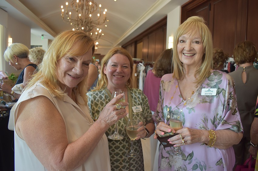 Carol Osten, Sara Osten and Jayne Kotey, who are the design team for the event, socialize before the fashion show begins.