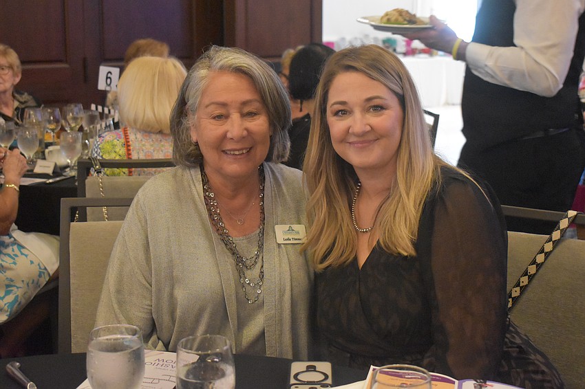 Leslie Timme, a member of the University Park Women's Club for eight years, and Jessica Ryherd, the executive director of Feeding Empty Little Tummies, socialize at the 