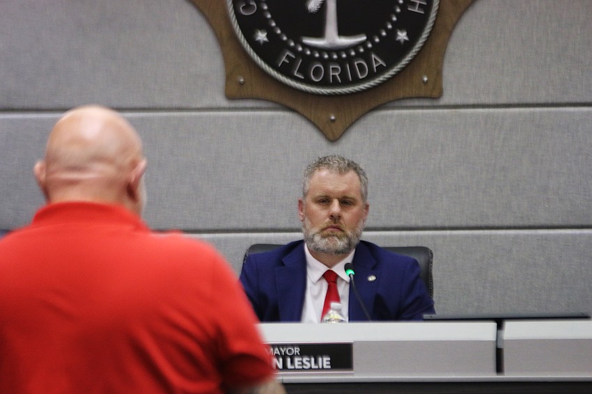 Ormond Beach Mayor Jason Leslie listens as a Tomoka Oaks resident — one of over 50 public speakers — shares his opinion on the Tomoka Reserve development at the public hearing on March 24. Photo by Jarleene Almenas