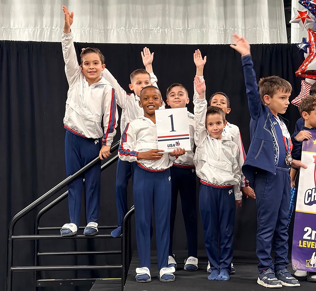 Gymnastics USA boys level 4 team celebrating finishing first in the state.